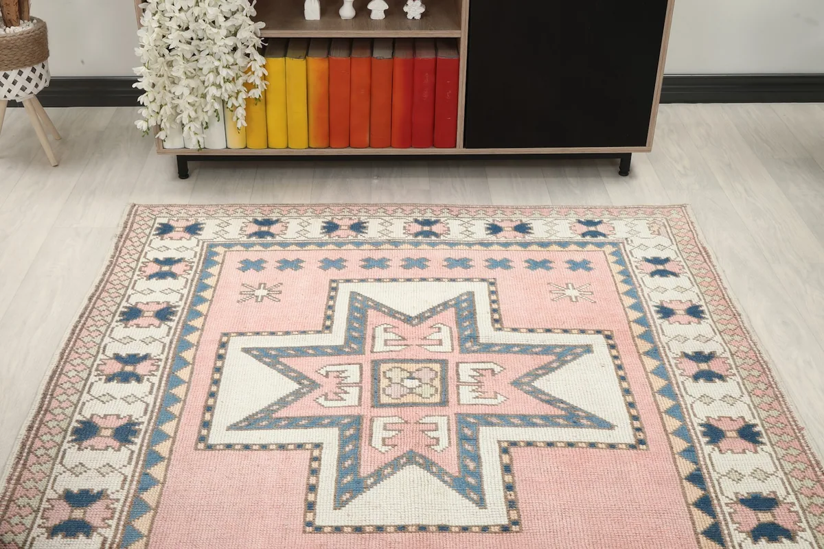 Angled view of the rose geometric rug, focusing on the upper portion and surrounding room elements.