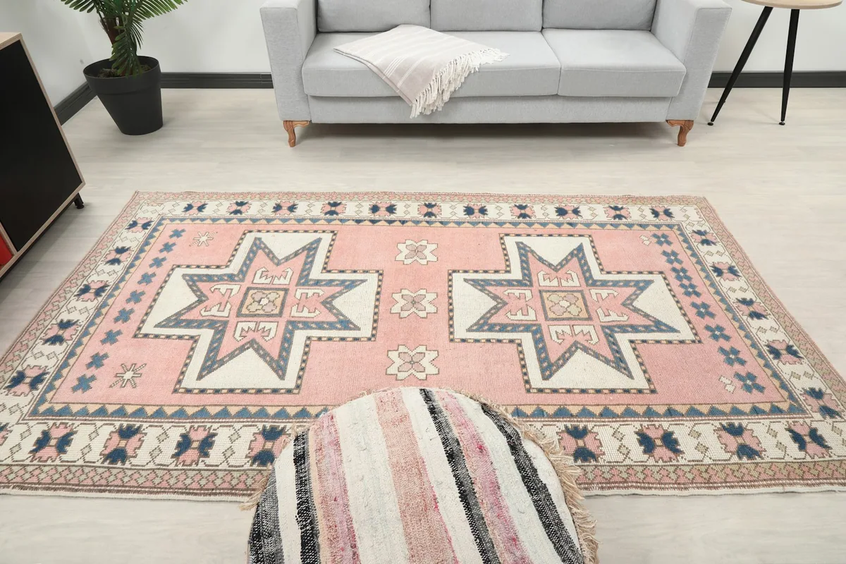 Overhead perspective of the rose rug in the room, with a view of the full design and surrounding furniture.
