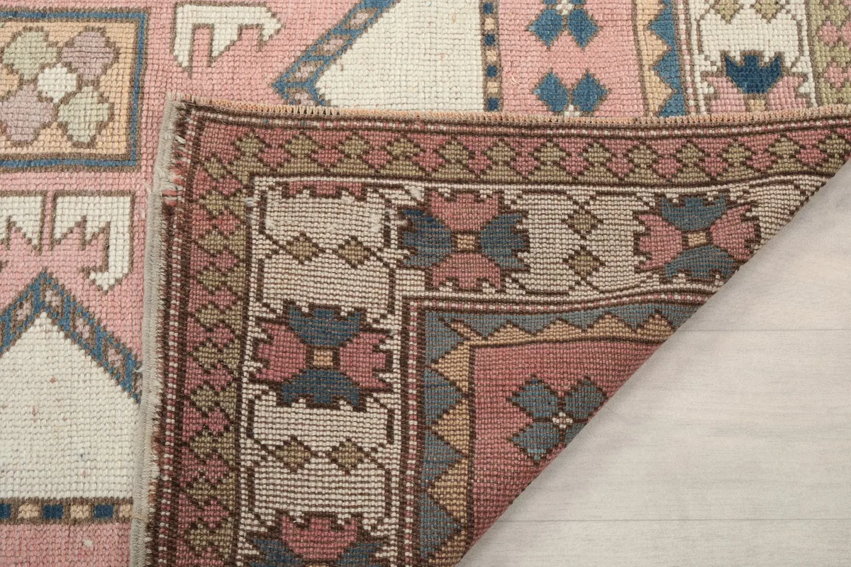 Close-up of the rug's back, showing the tight hand-knotted construction and cotton foundation.
