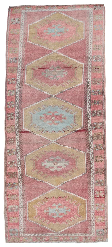 Full overhead view of the vintage Anatolian runner rug with rose and tan geometric patterns