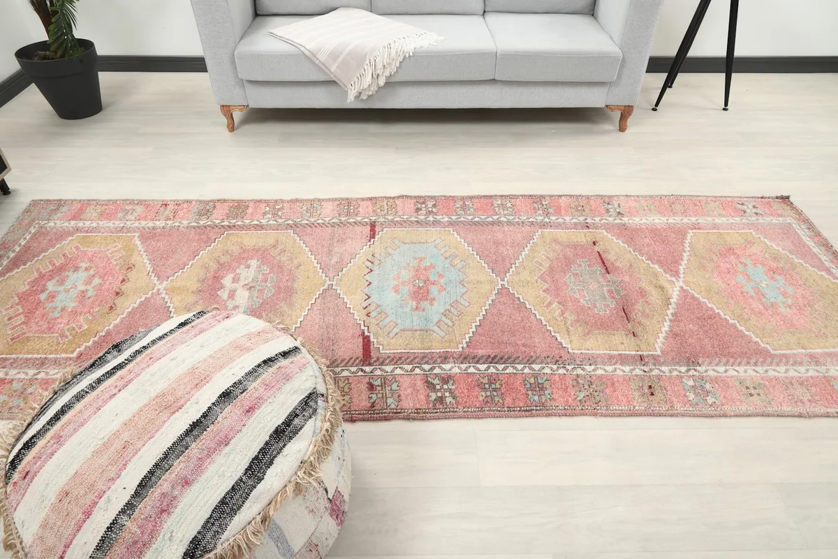 Wide shot of the runner rug in a living area, positioned between furniture