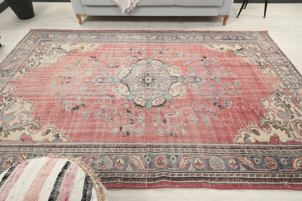Overhead view of the rose medallion vintage rug in a room, showing its full design