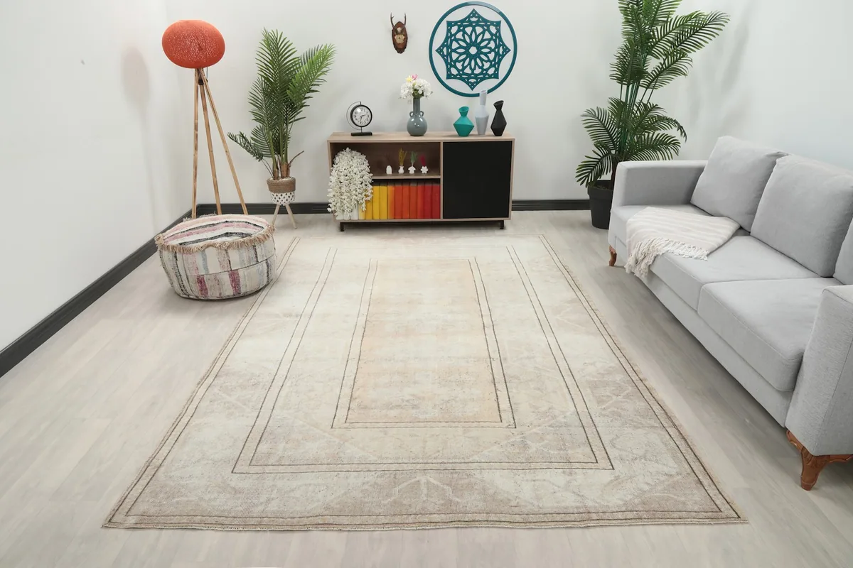 Vintage beige and gold area rug displayed in a modern living room setting