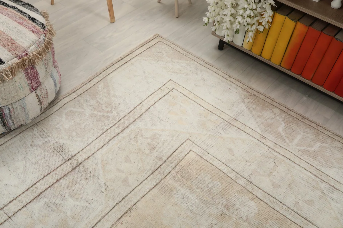Detail of the outer border design and corner of the beige area rug