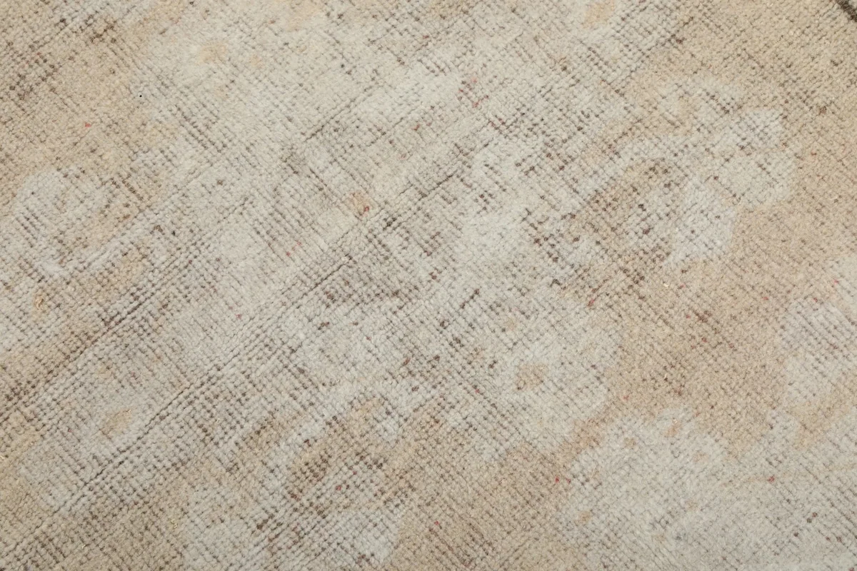 Close-up of the low wool pile showing texture and distressed patina