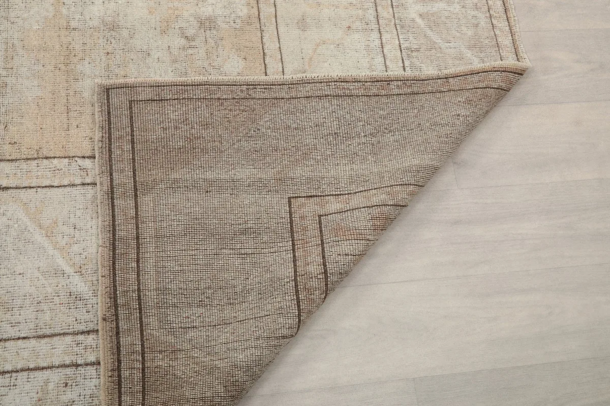 Underside of the rug showing the sturdy cotton foundation and knotting