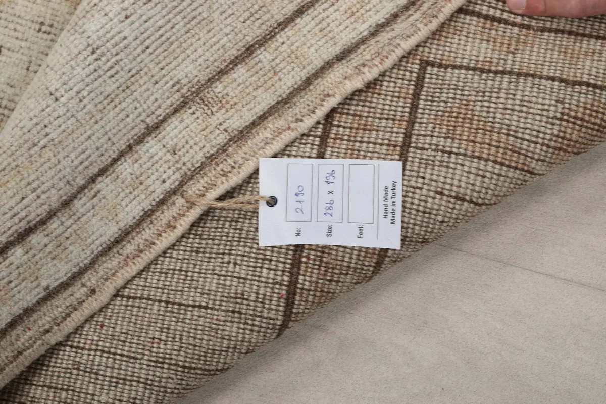 Close-up of the rug's label confirming size and origin