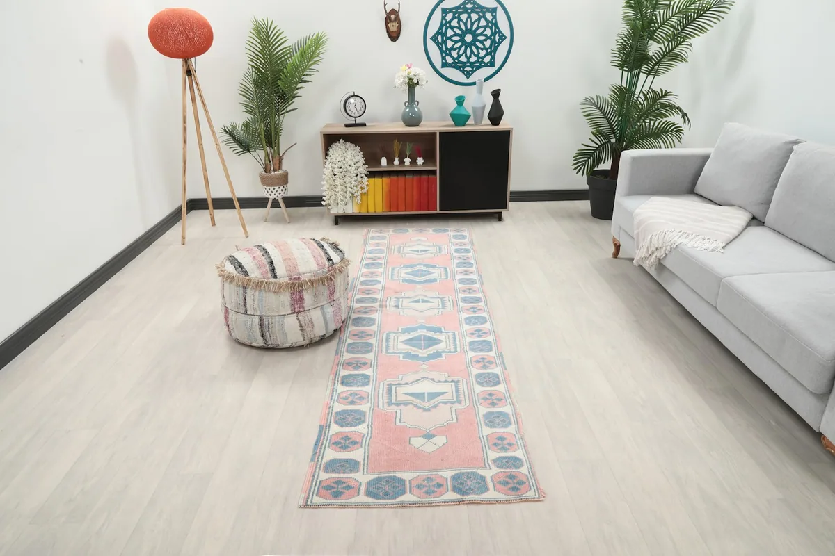 Runner rug in a modern living space with a light-colored sofa and ottoman