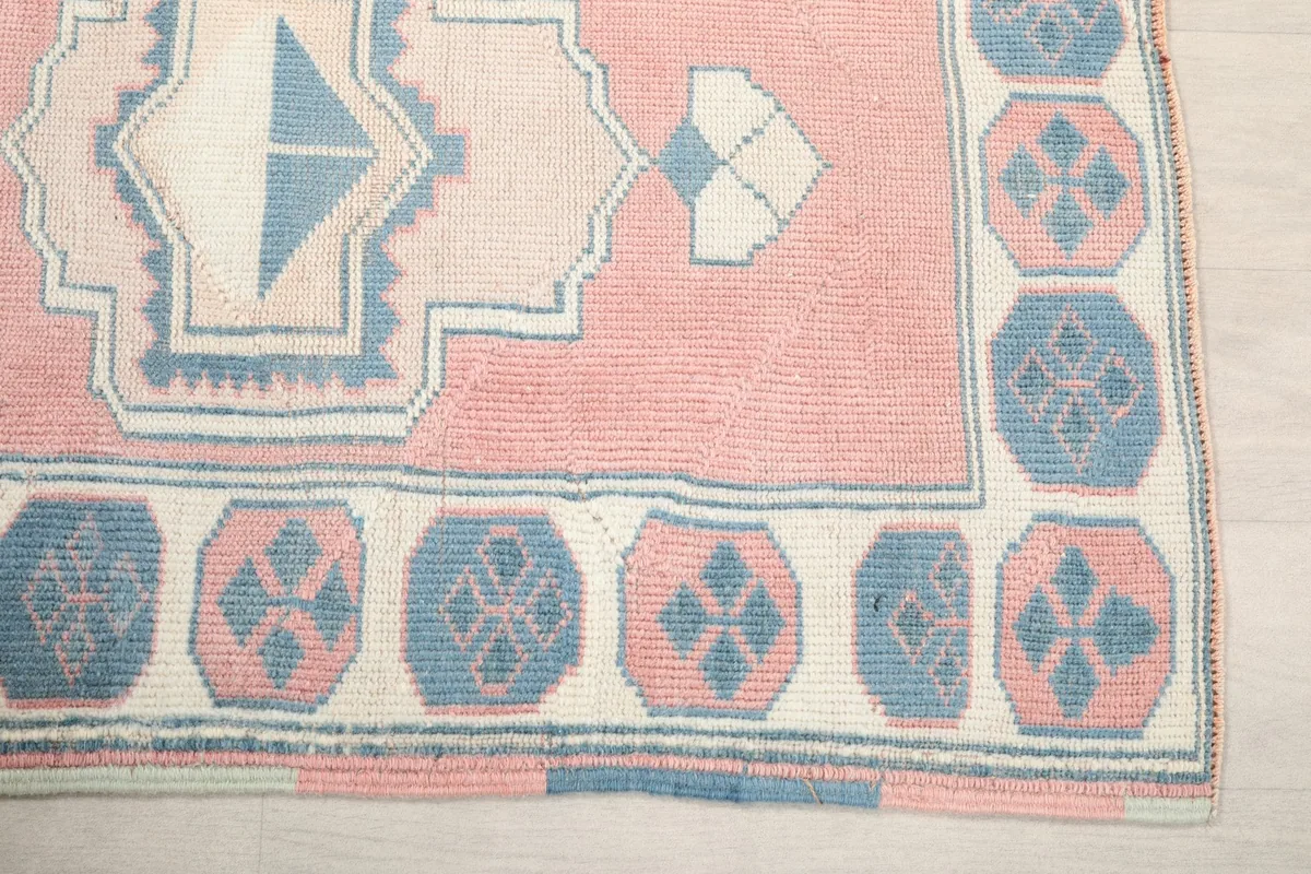 Detail of the runner's corner, showing the rose field and blue border motifs