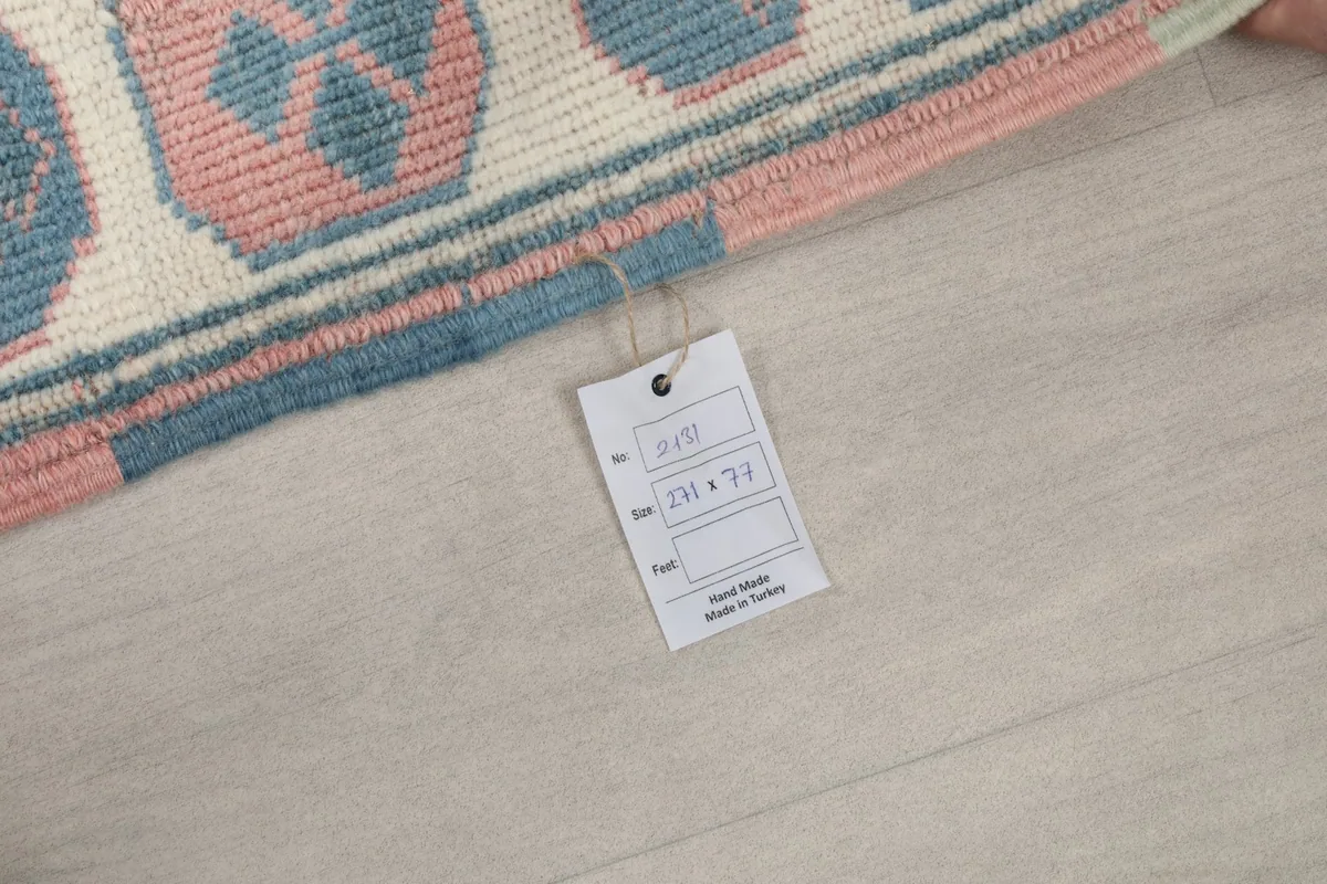 Close-up of the product tag attached to the rug, displaying size and origin