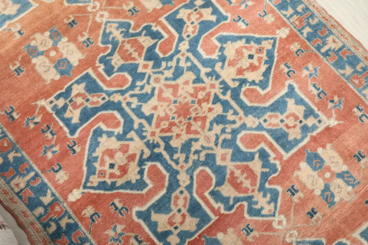 Close-up showing the central geometric motif and colors of the rug.