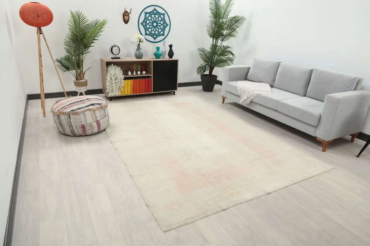 Angle view of the cream and rose area rug in a modern living space