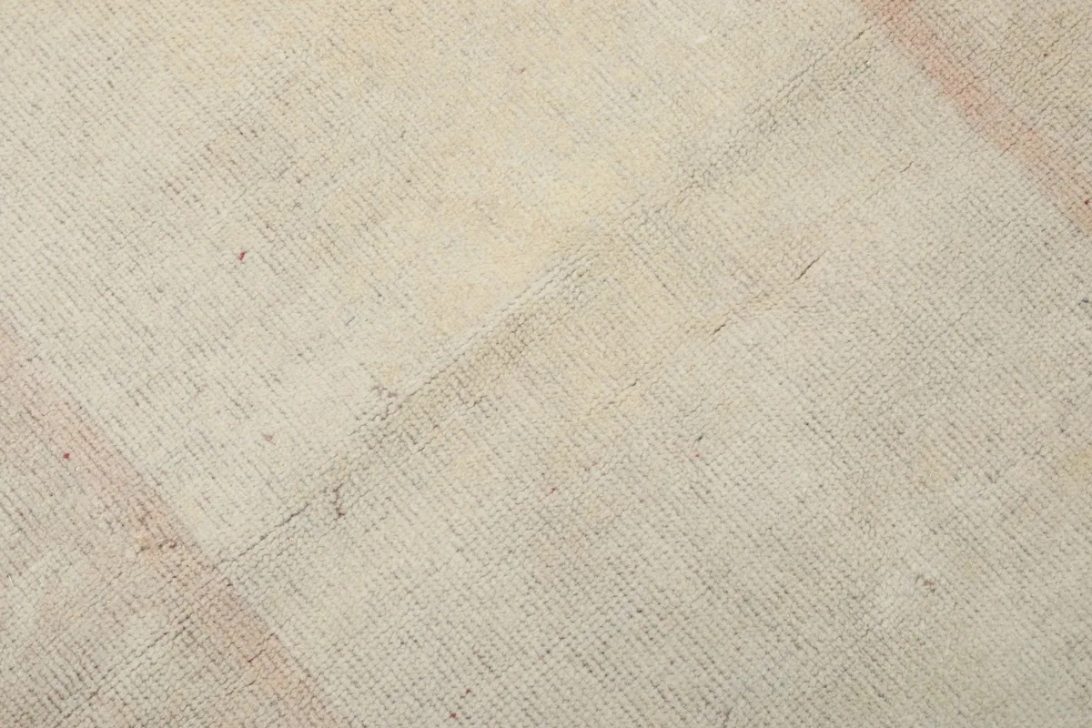 Texture detail of the low wool pile and hand-knotted weave of the vintage rug
