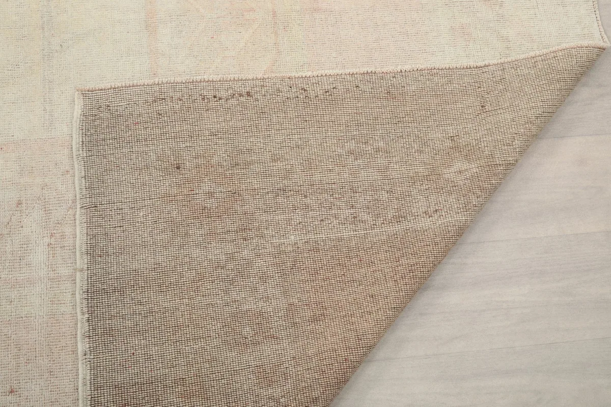 Underside of the hand-knotted rug, showing the cotton foundation
