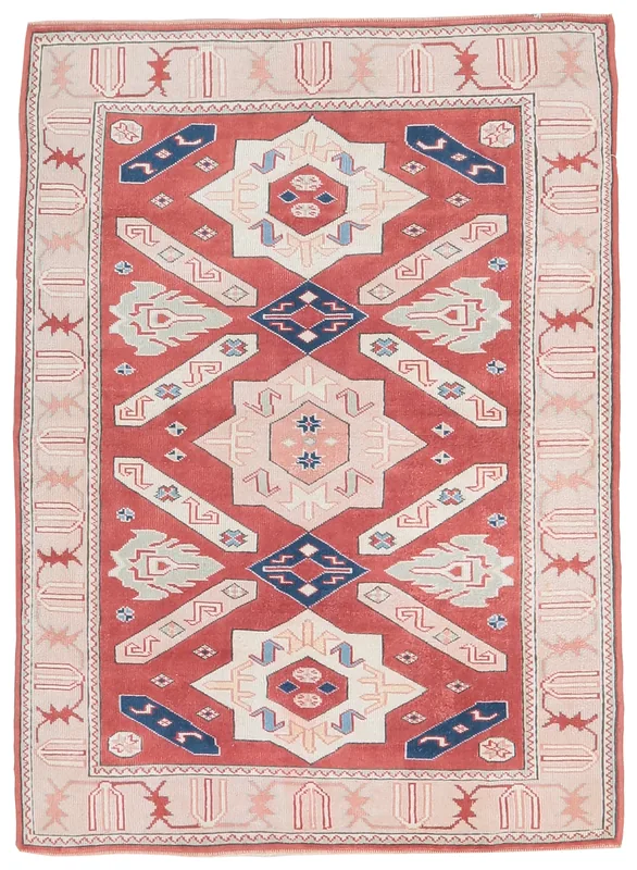 Full top view of the vintage Anatolian rug with red field and geometric patterns on a white background.
