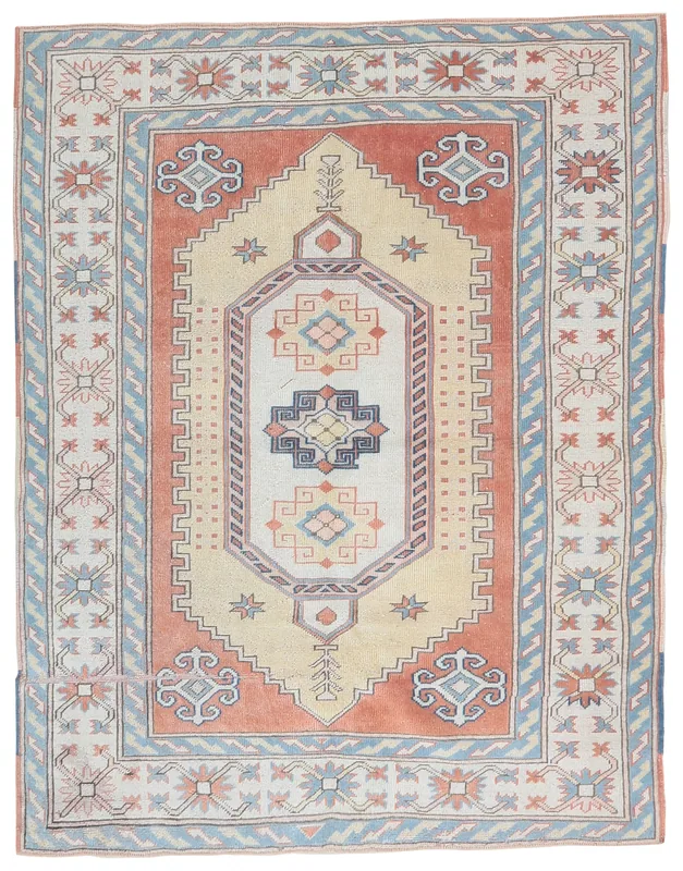 Full top view of the beige and rust vintage Anatolian rug with blue geometric patterns