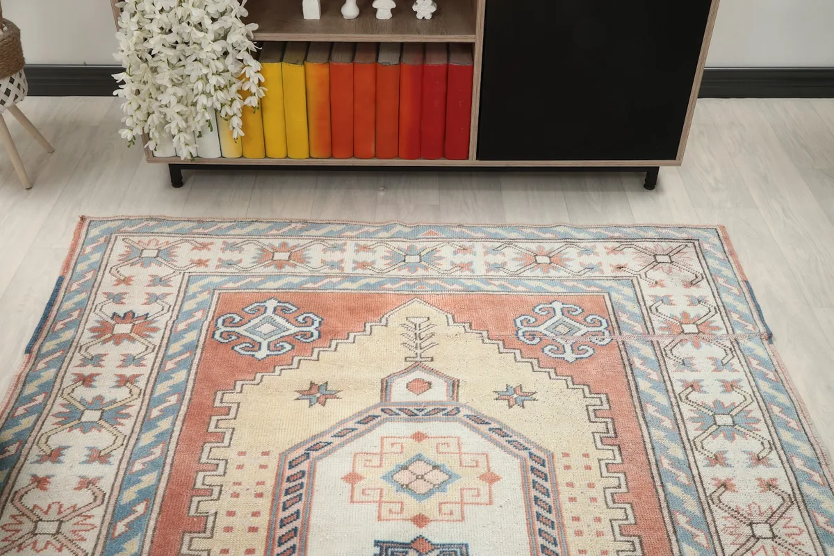 View of the rug in a room setting from a higher angle, showing the full design