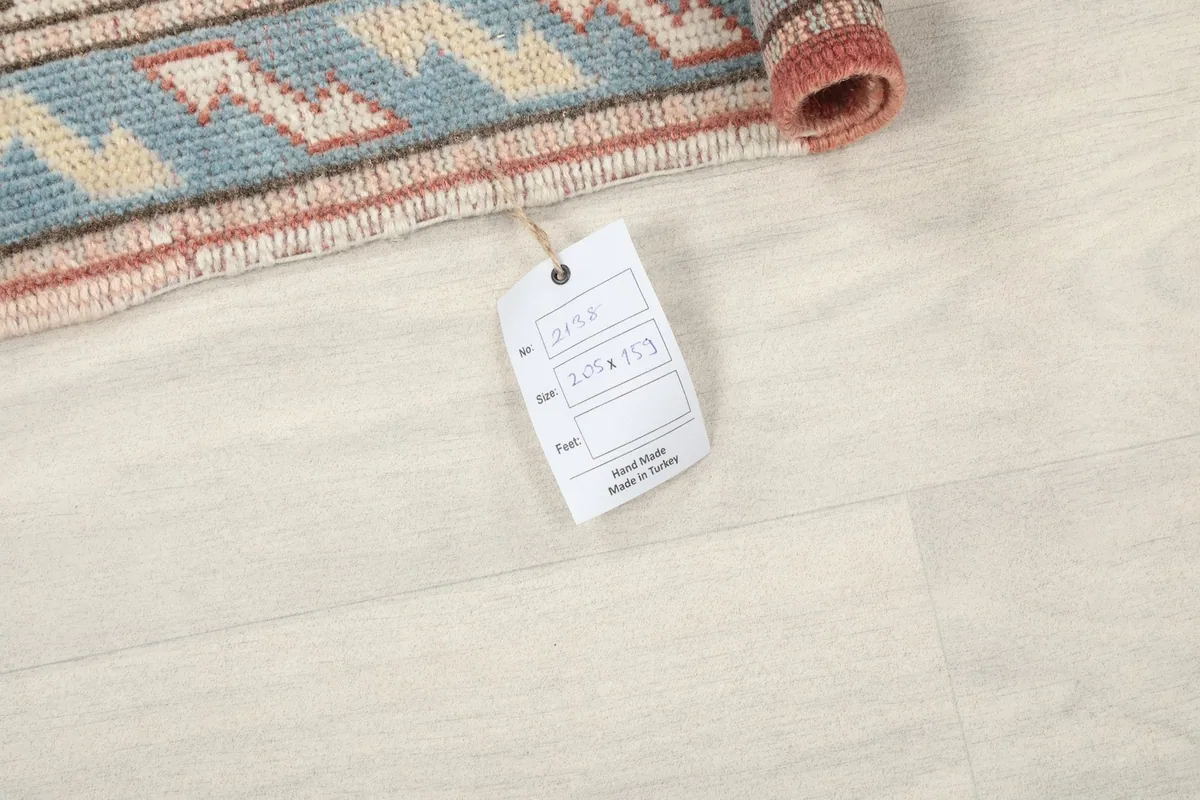 Close-up of the rug's tag displaying size and origin information