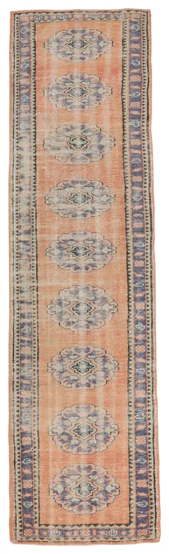 Full top view of the orange and blue Anatolian runner rug on a white background
