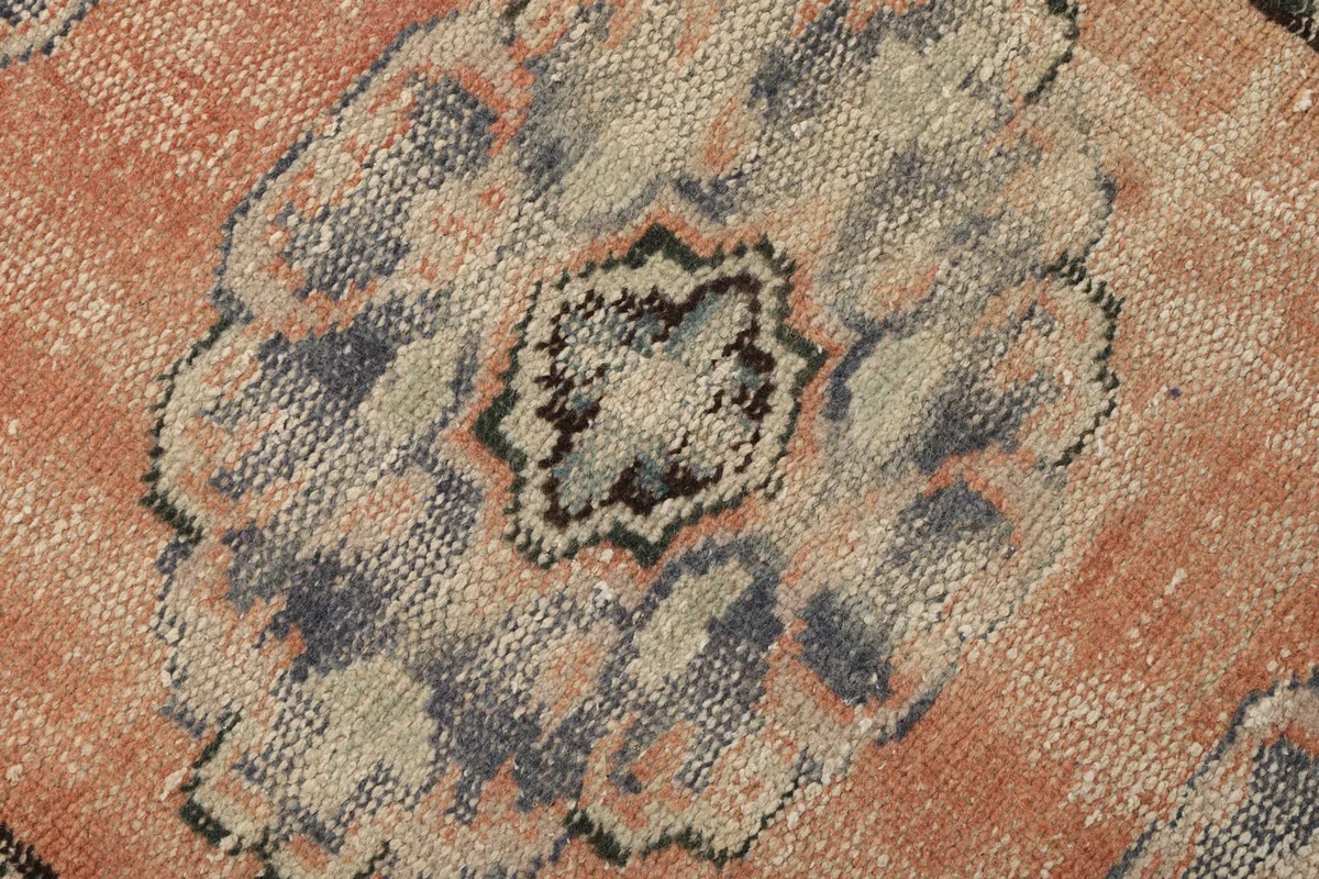 Detailed view of the low pile and intricate knotting of a central medallion