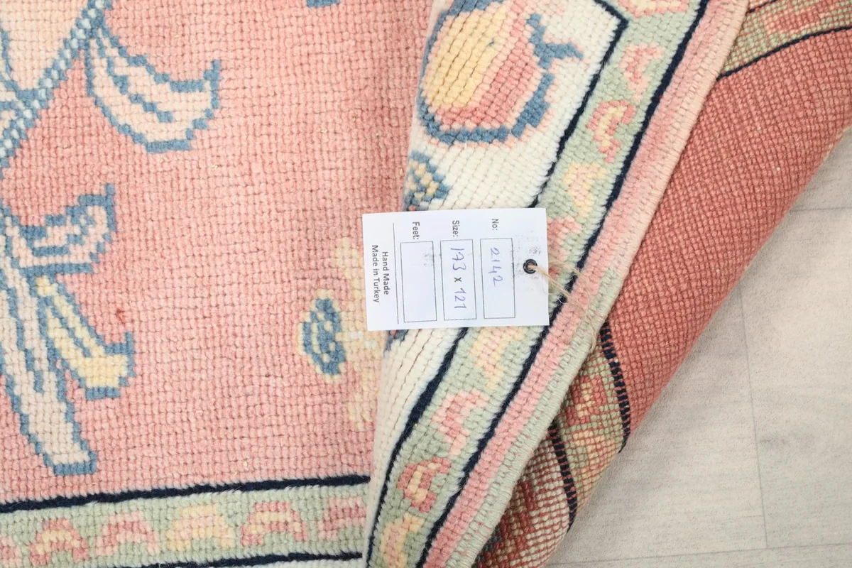 Close-up of the rug's label with size and item information, folded back to show the reverse side