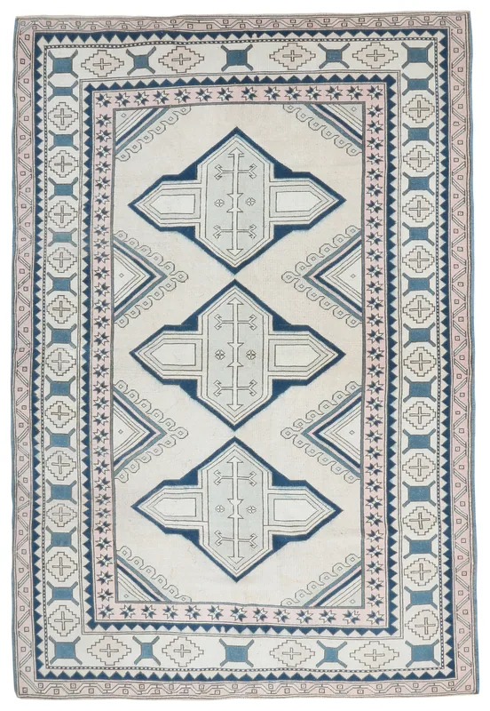 Full top view of the 6'7" x 9'11" ivory and blue geometric vintage Anatolian rug