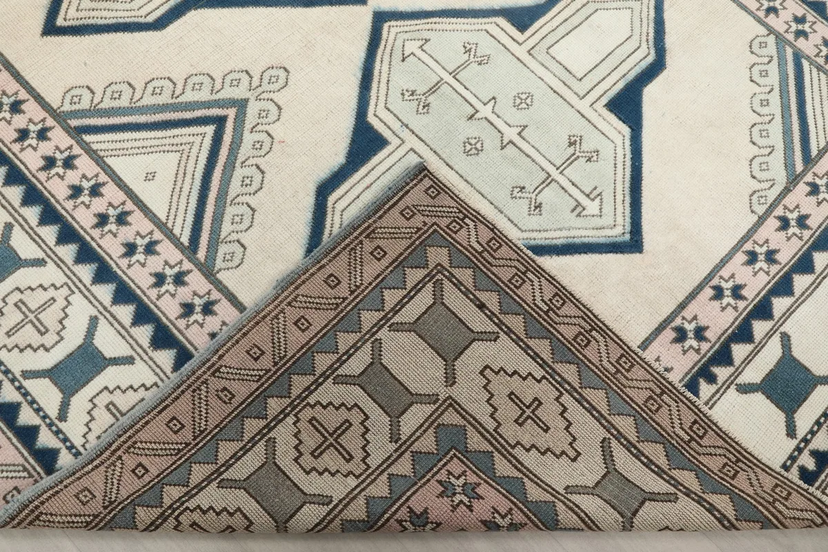 View of the back of the rug, showing the cotton foundation and knotting detail