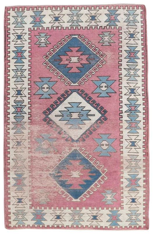Full top view of the 3'10" x 6'6" rose and ivory geometric Anatolian area rug