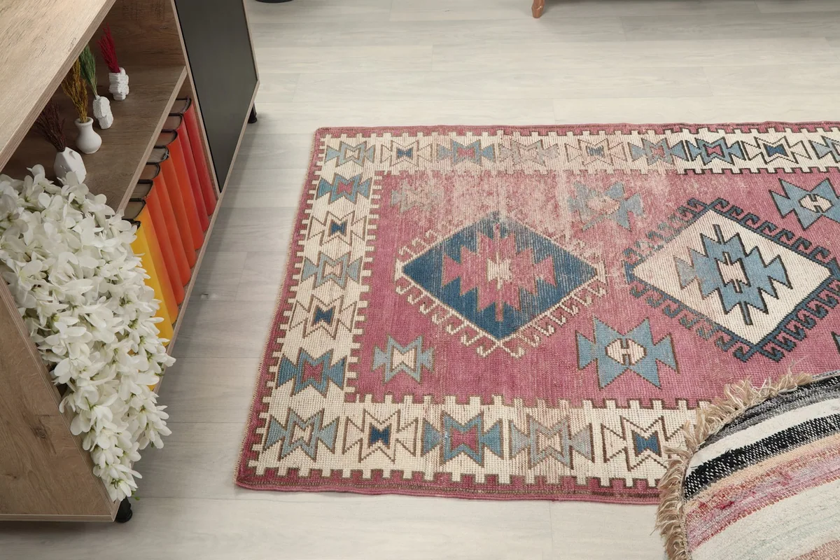 Side angle view of the rug on a light floor, showing its texture and color variations