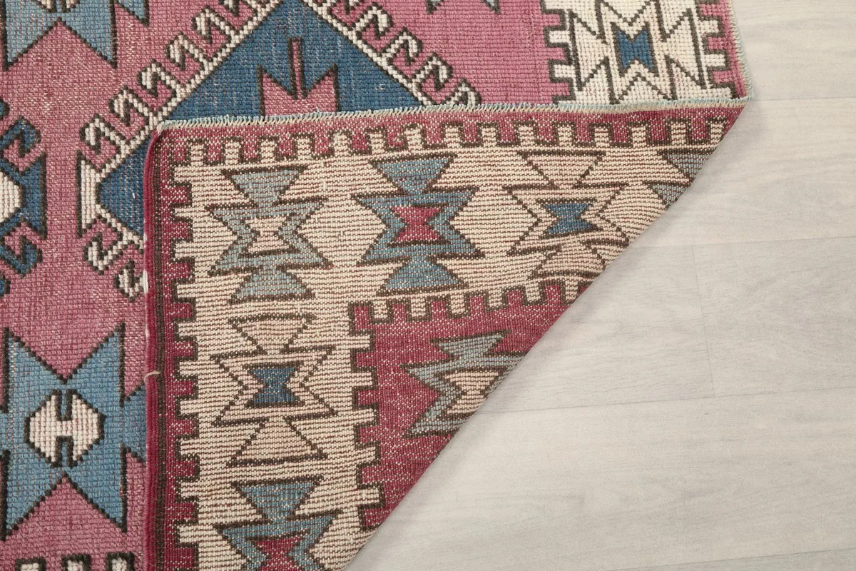 Underside of the rug, revealing the cotton foundation and hand-knotted construction