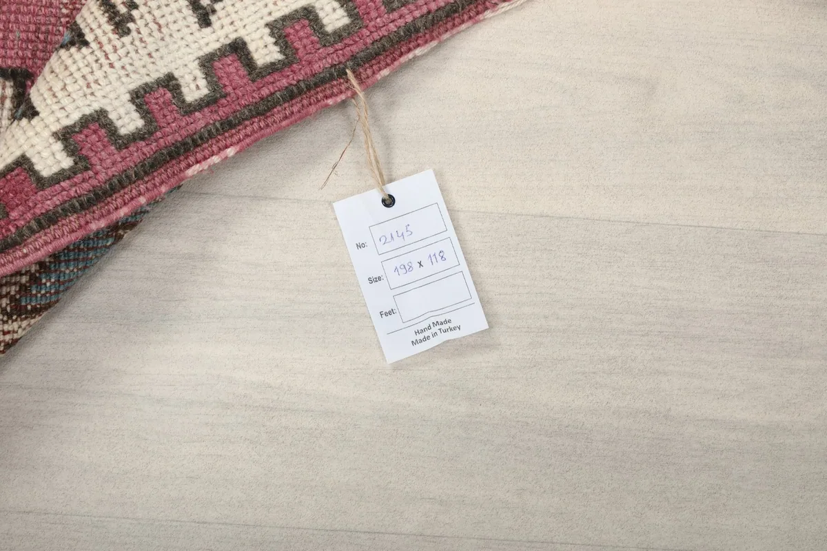 Product tag attached to the rug, displaying size information and origin