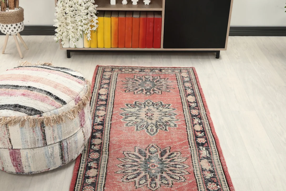 Overhead view of the rug in a room setting, emphasizing its length and decorative elements.