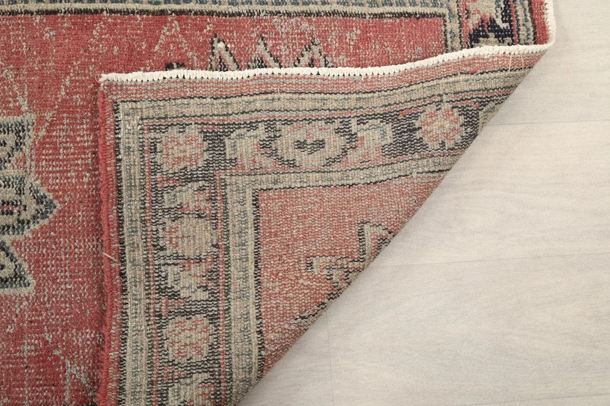 Another folded corner view, showing the construction and the reverse side of the hand-knotted rug.