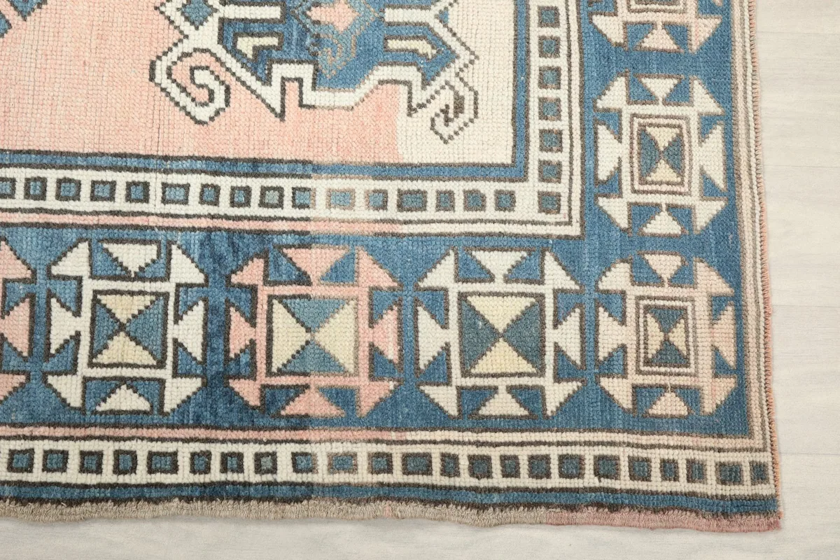 Detail of the blue geometric border and corner design of the Anatolian rug