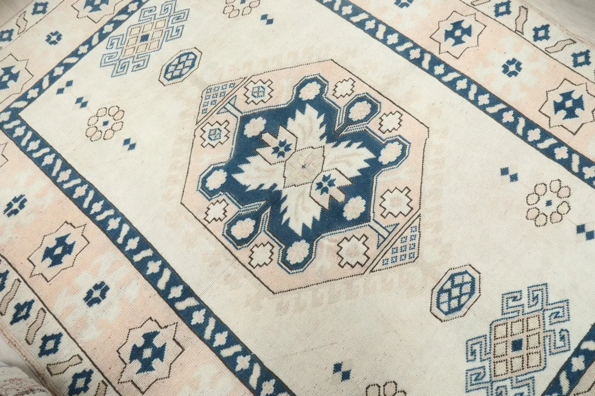Close-up of the central geometric medallion with navy and cream details