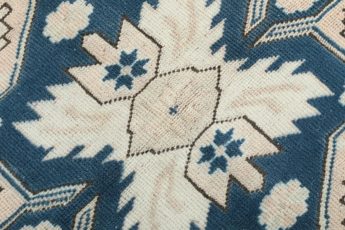 Macro view of the hand-knotted wool pile texture and color variations