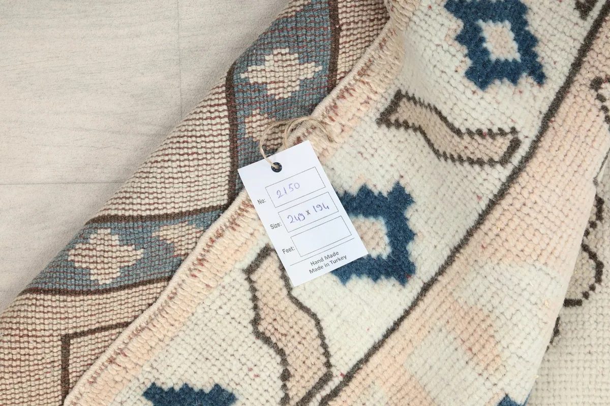 Tag showing rug dimensions and origin, attached to the vintage wool rug