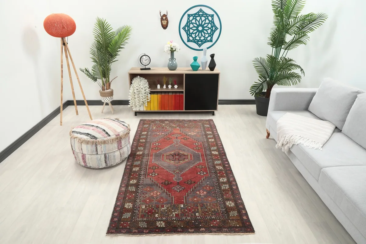 Vintage Anatolian rug in a living room setting with a sofa and decor