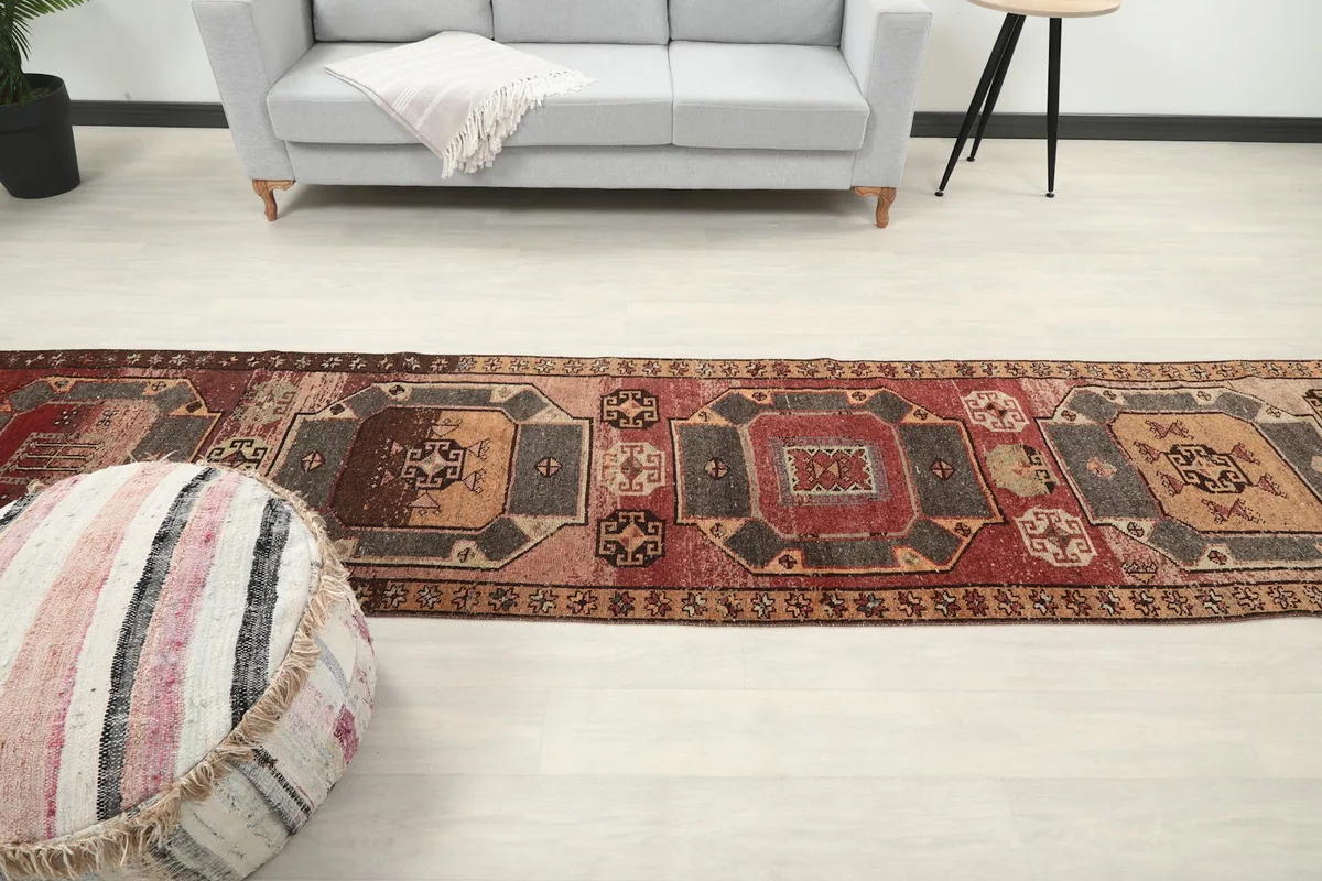 Overhead long shot of the runner rug in the room, emphasizing its length and how it fills the space.