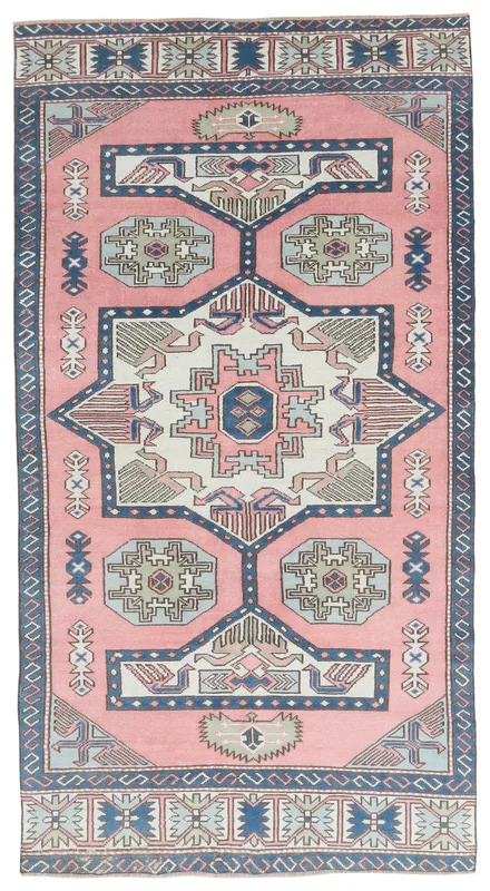 Full overhead view of the rose and navy geometric vintage Anatolian rug