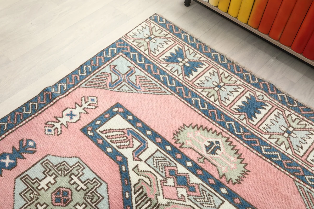 Top-down angle of the rug's corner, highlighting the intricate border and field patterns