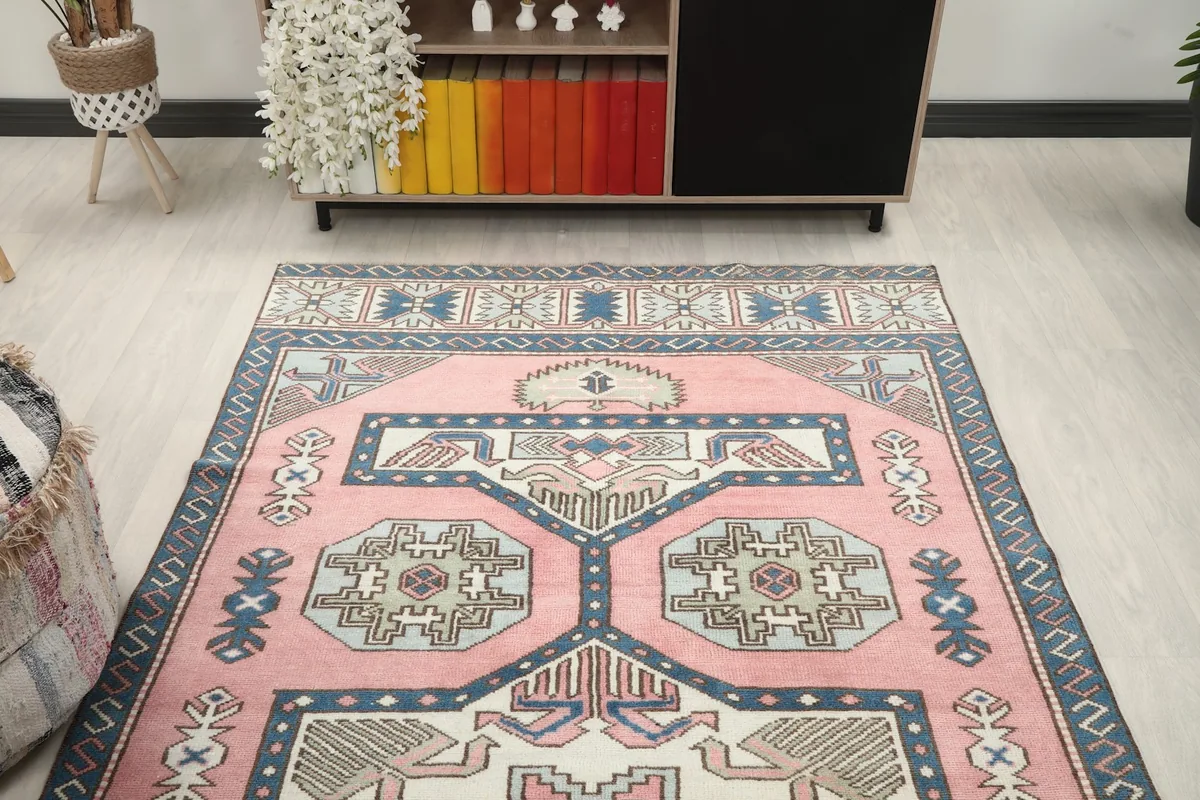 Overhead view of the rose rug in a room, showing its length and design