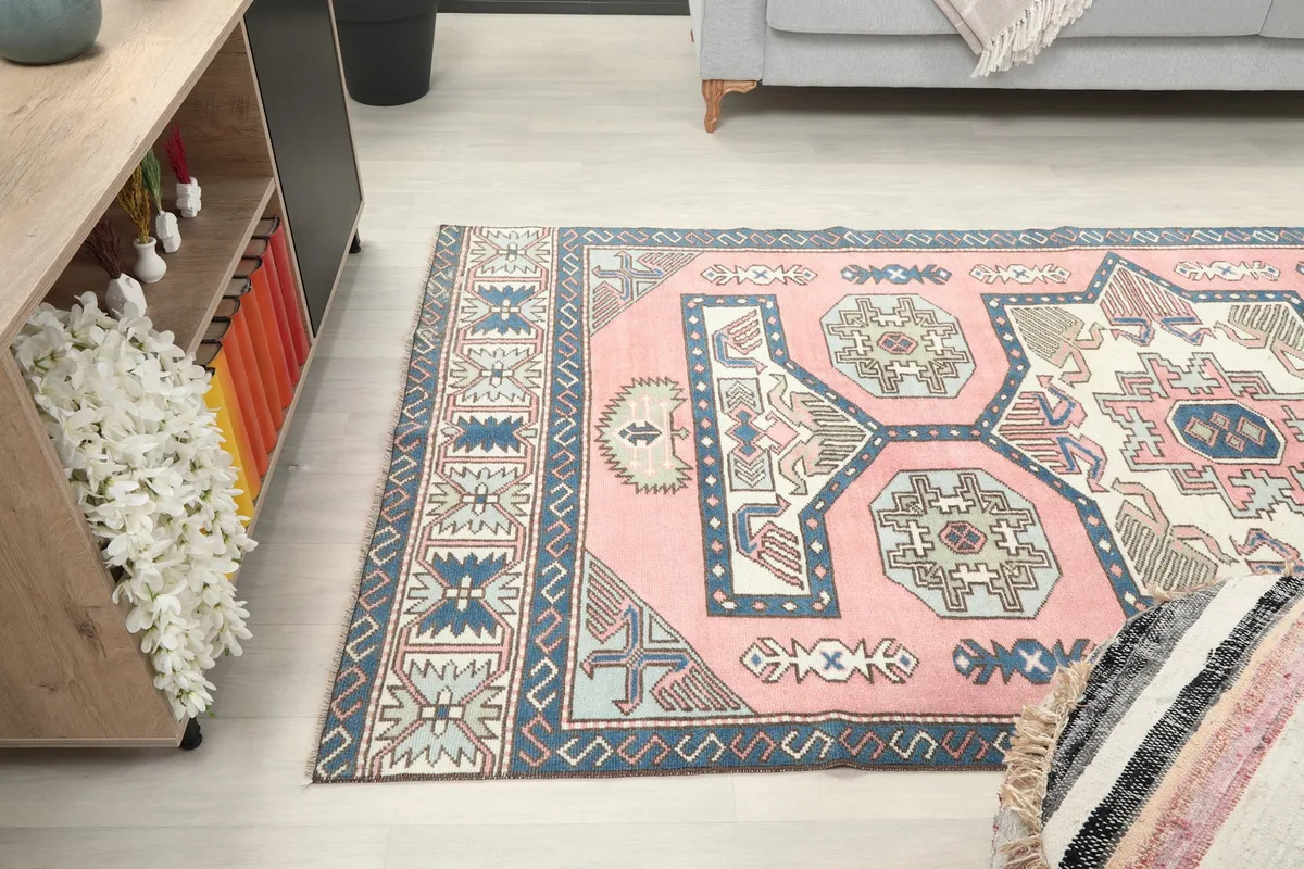 View of the rug from the side, showcasing its colors and texture next to furniture