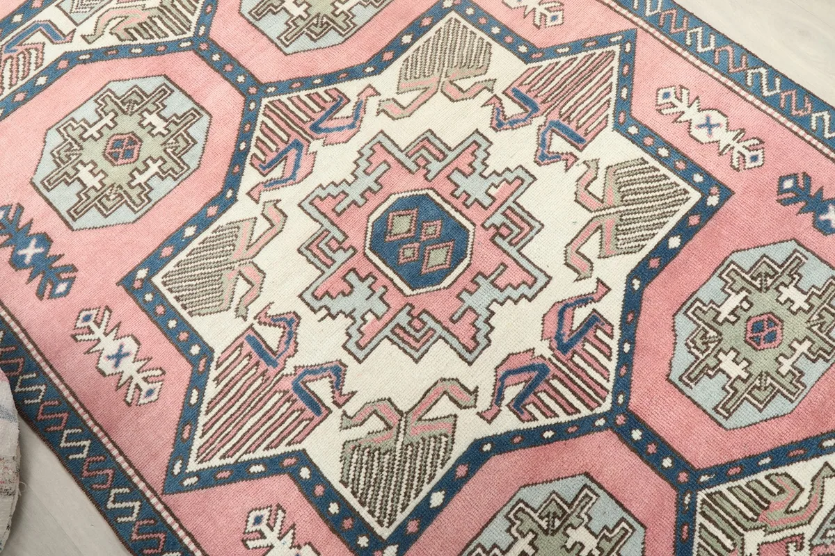 Close-up of the central ivory medallion and surrounding rose and navy motifs