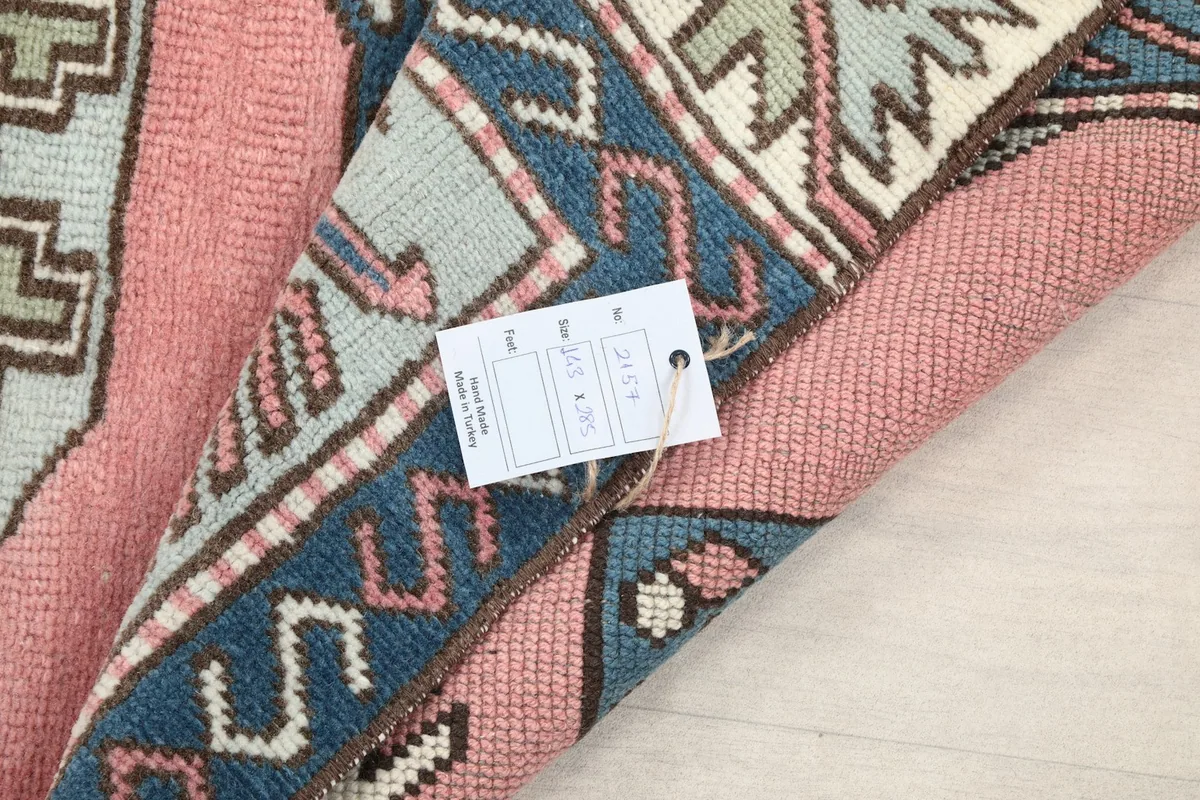 Close-up of the rug's back with a product tag, showing construction details