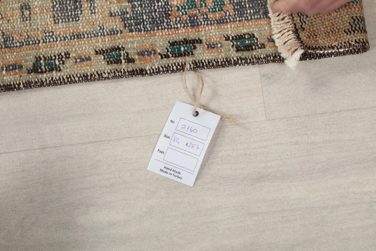 Product tag attached to the rug's edge, displaying size and origin information.