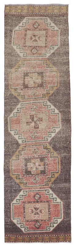 Full top view of the vintage Anatolian runner rug with charcoal field and rose geometric patterns.