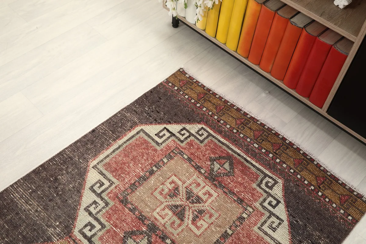 Angled view from above, showing the rug's pattern and its placement near a bookshelf.