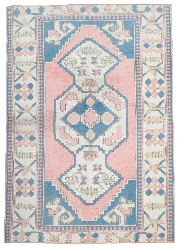 Full overhead view of the vintage pink and blue geometric Anatolian area rug