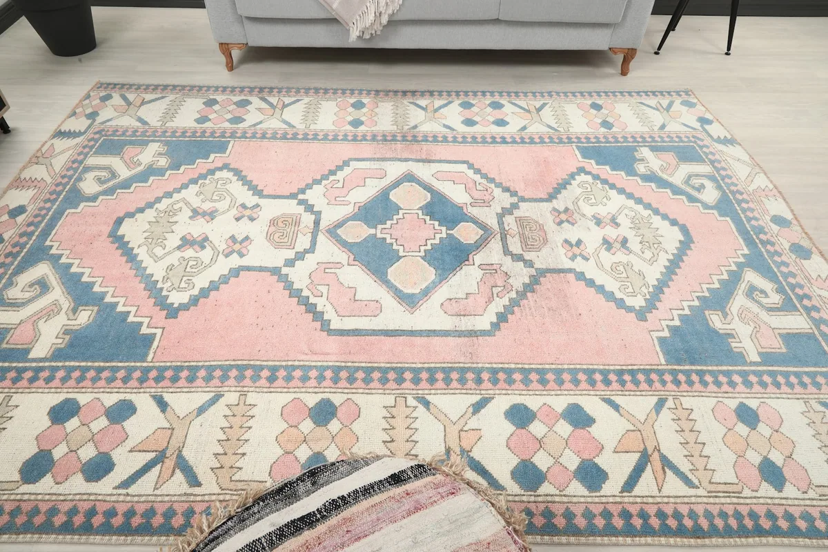 Frontal view of the pink and blue rug in a decorated living space